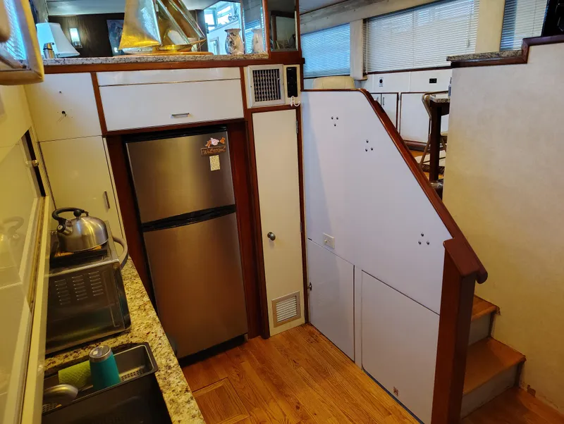 Slide: The Image of Interior of 1976 Bertram 58 Flybridge Motor Yacht with kitchen and stairs. - 16