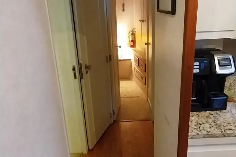 Slide: The Image of Interior hallway of a 1976 Bertram 58 Flybridge Motor Yacht with kitchen appliances. - 17