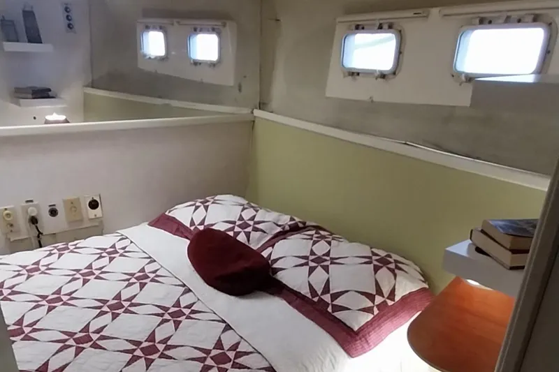Slide: The Image of Cozy bedroom in a 1976 Bertram 58 Flybridge Motor Yacht with quilted bedding. - 21