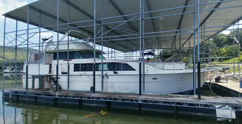 Slide: The Image of 1976 Bertram 58 Flybridge Motor Yacht docked under covered marina. - 3