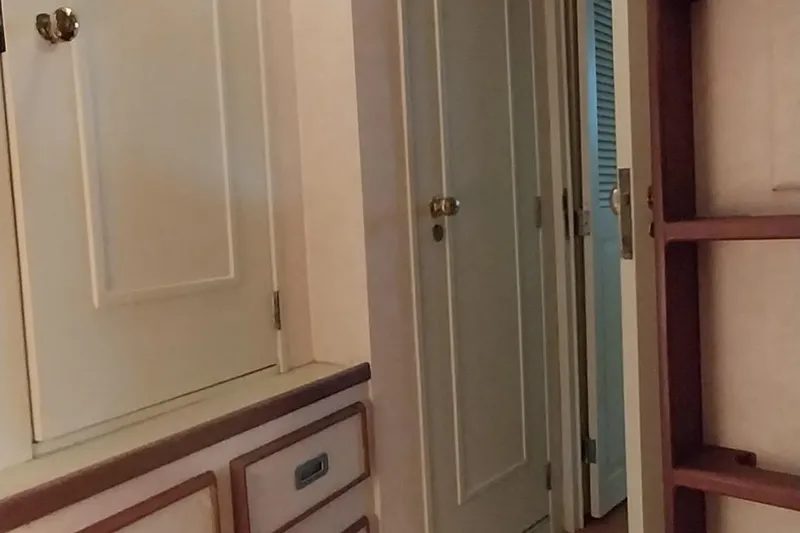 Slide: The Image of Interior of 1976 Bertram 58 Flybridge Motor Yacht with cabinets and doors. - 30