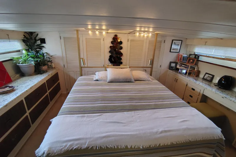 Slide: The Image of Luxurious bedroom interior of a 1976 Bertram 58 Flybridge Motor Yacht with cozy decor. - 34