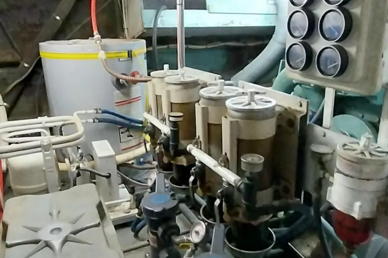 Slide: The Image of Engine room of a 1976 Bertram 58 Flybridge Motor Yacht with various mechanical components. - 37