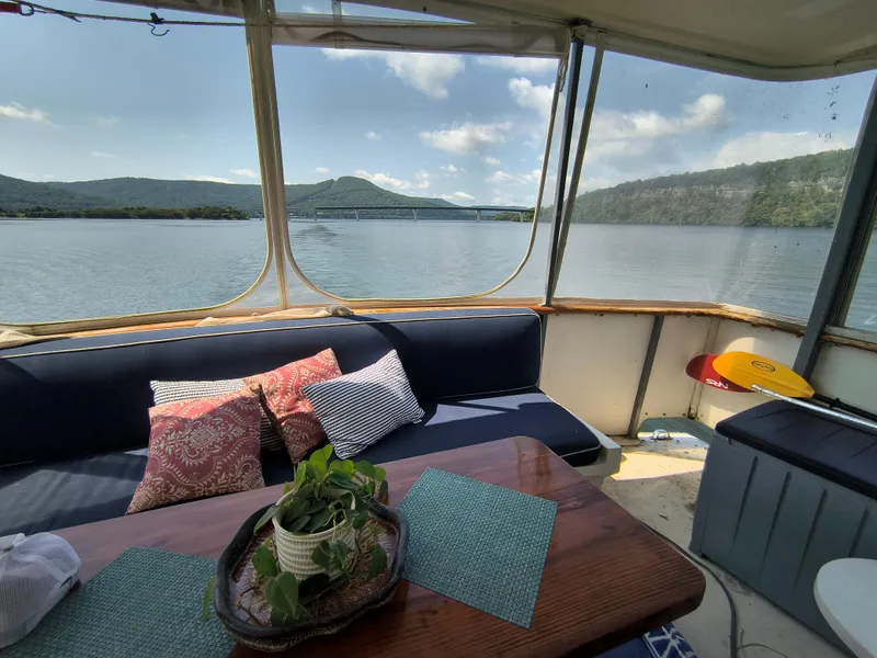 Slide: The Image of Interior view of 1976 Bertram 58 Flybridge Motor Yacht with scenic lake backdrop. - 43