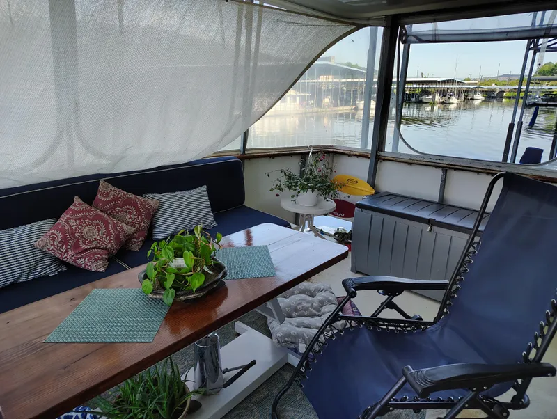 Slide: The Image of 1976 Bertram 58 Flybridge Motor Yacht interior with cozy seating and lake view. - 44