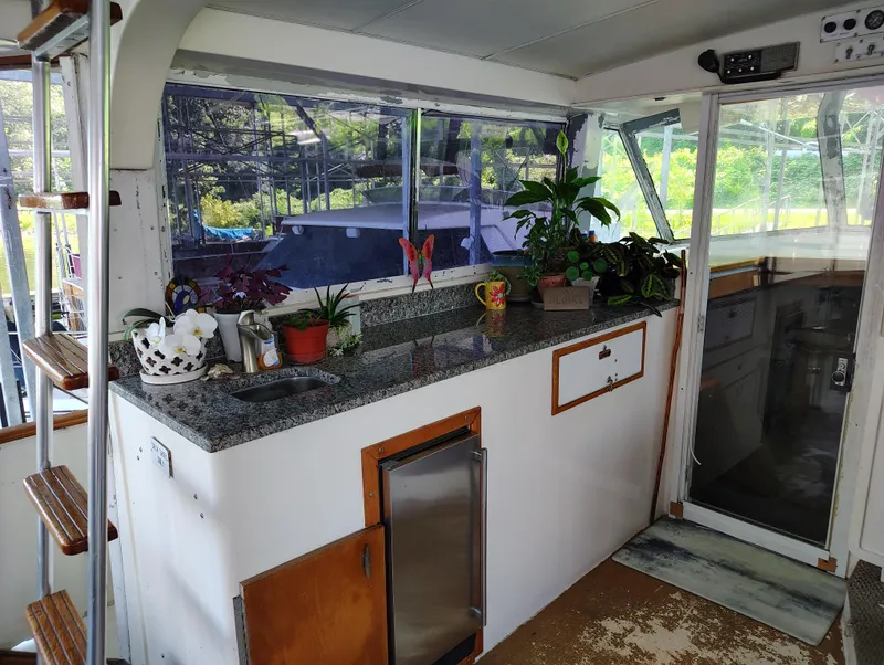 Slide: The Image of 1976 Bertram 58 Flybridge Motor Yacht interior with plants and granite countertop. - 46