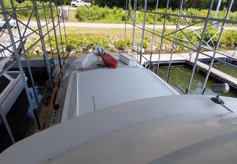 Slide: The Image of 1976 Bertram 58 Flybridge Motor Yacht docked under a covered marina. - 51