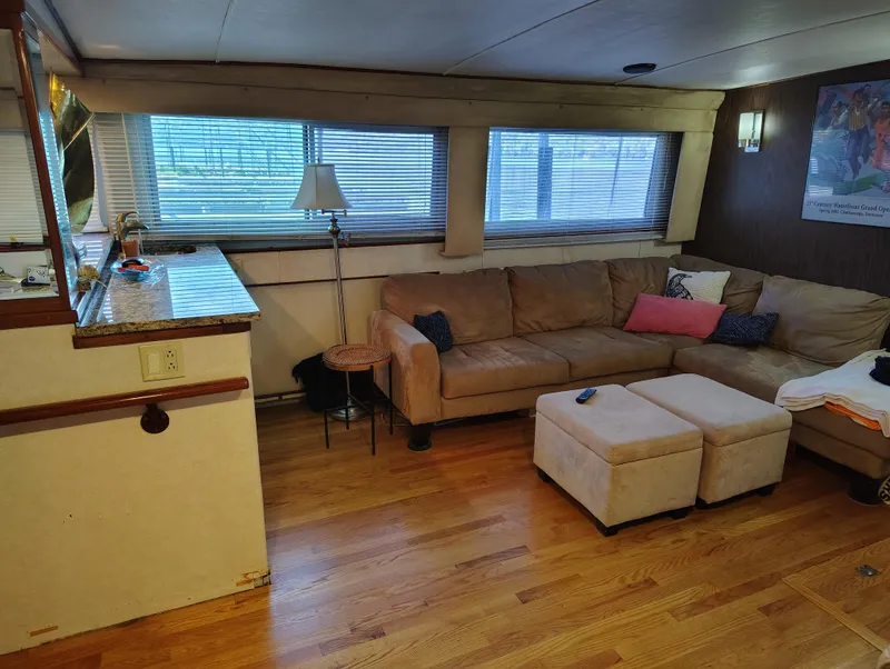 Slide: The Image of Interior of 1976 Bertram 58 Flybridge Motor Yacht with cozy seating and wooden flooring. - 8