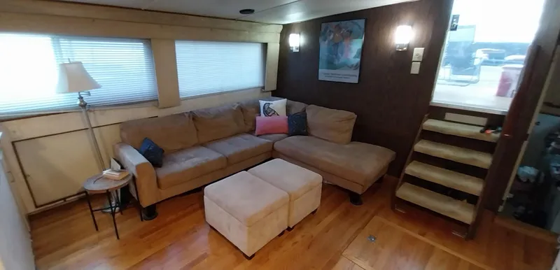 Slide: The Image of Cozy living area in 1976 Bertram 58 Flybridge Motor Yacht with sectional sofa and ottomans. - 9