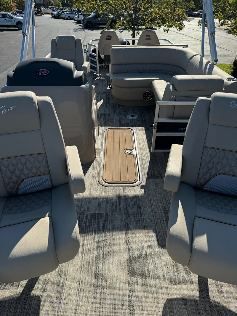 Slide: The Image of 2024 Ranger Reata 223F pontoon boat interior with plush seating and modern design. - 4