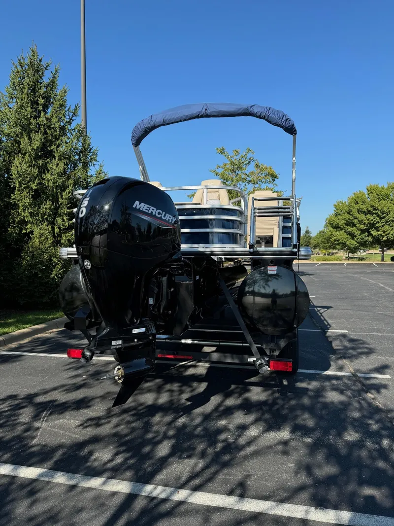 Slide: The Image of 2024 Ranger Reata 223F boat with Mercury outboard motor in parking lot. - 5