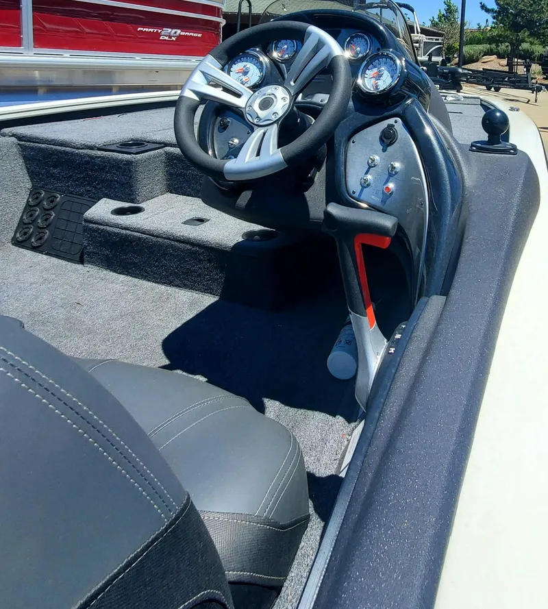 Slide: The Image of 2024 Tracker Pro Team 195 TXW Tournament Edition boat cockpit and steering wheel. - 3