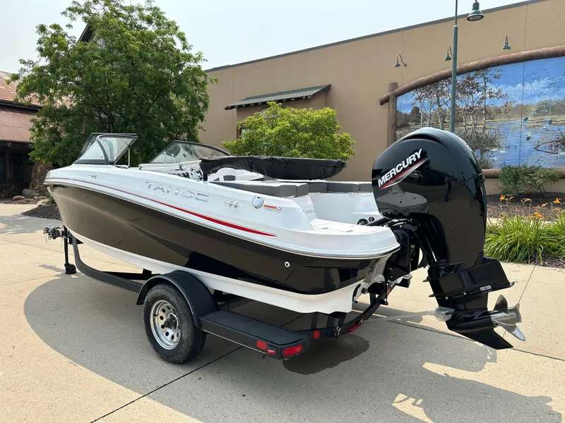 Slide: The Image of 2024 Tahoe 200 S boat with Mercury outboard motor on trailer. - 2