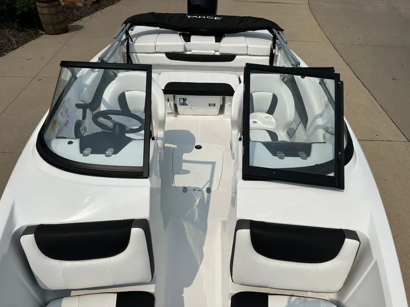 Slide: The Image of 2024 Tahoe 200 S boat interior with open windshield and white seating. - 4