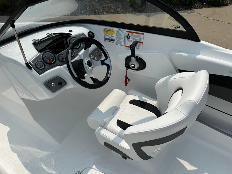 Slide: The Image of 2024 Tahoe 200 S boat cockpit with steering wheel and captain's chair. - 5