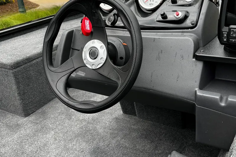 Slide: The Image of 2024 Tracker Pro 170 boat steering wheel and dashboard close-up. - 2