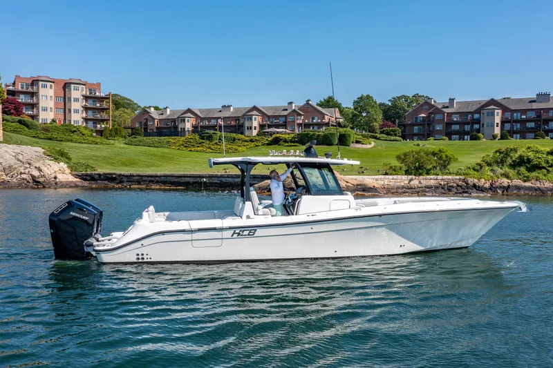 Slide: The Image of 2024 HCB 39 Speciale boat cruising near waterfront homes. - 10