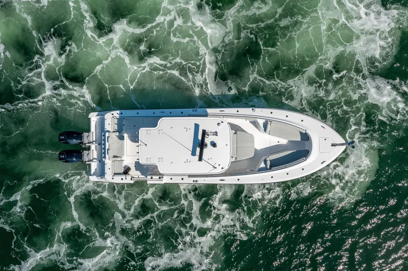 Slide: The Image of Aerial view of 2024 HCB 39 Speciale boat cruising through green ocean waters. - 12