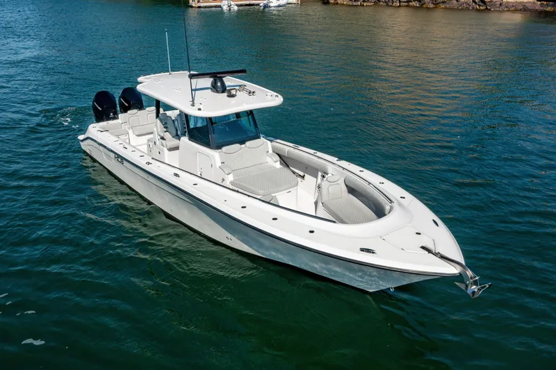 Slide: The Image of 2024 HCB 39 Speciale boat on water, white exterior, luxury center console. - 15