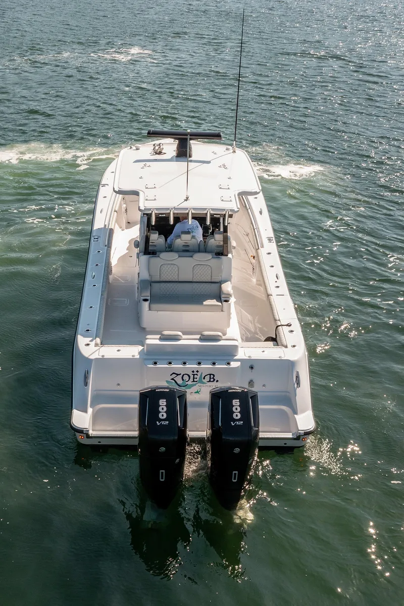 Slide: The Image of 2024 HCB 39 Speciale boat cruising on open water, rear view. - 16