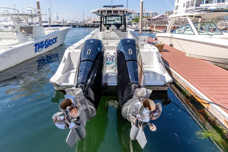 Slide: The Image of 2024 HCB 39 Speciale boat with twin outboard engines docked at a marina. - 18