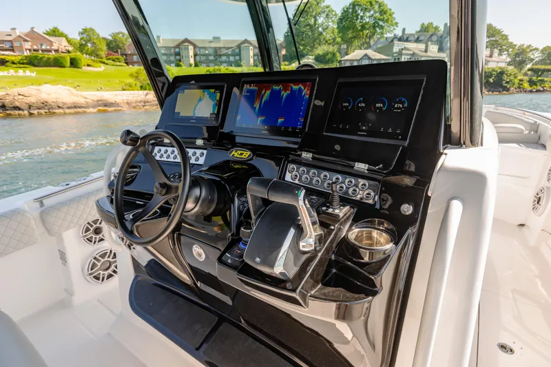 Slide: The Image of 2024 HCB 39 Speciale boat dashboard with advanced navigation and control systems. - 23