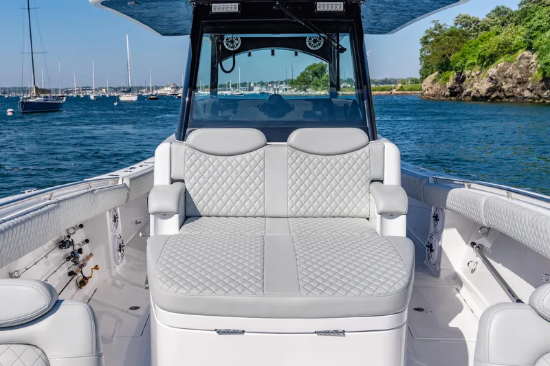 Slide: The Image of 2024 HCB 39 Speciale boat with luxurious seating on a scenic waterfront. - 27