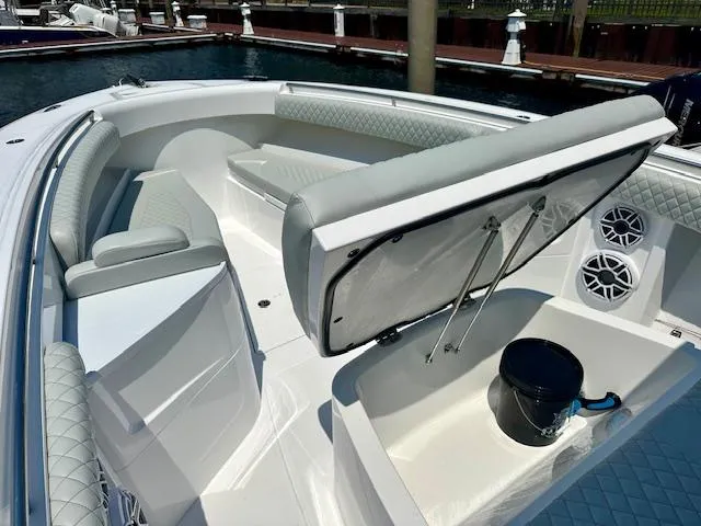 Slide: The Image of 2024 HCB 39 Speciale boat interior with seating and storage at marina. - 37