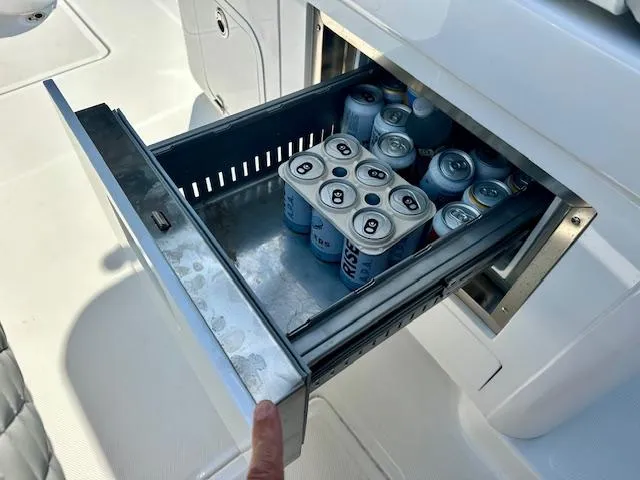 Slide: The Image of Built-in cooler drawer on 2024 HCB 39 Speciale boat, stocked with canned drinks. - 38