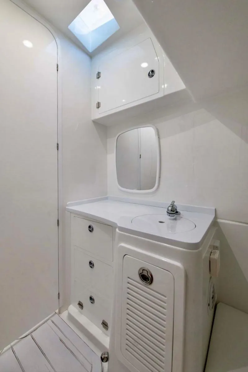 Slide: The Image of 2024 HCB 39 Speciale boat bathroom with white cabinetry and skylight. - 41