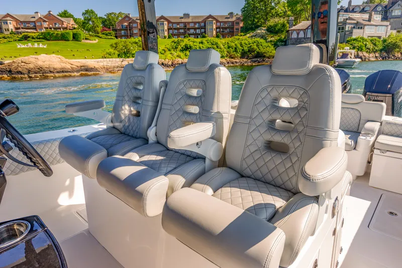 Slide: The Image of Luxurious seating on the 2024 HCB 39 Speciale boat with scenic waterfront view. - 7