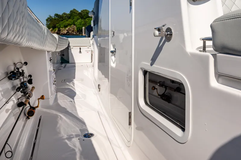 Slide: The Image of 2024 HCB 39 Speciale boat deck with fishing rods and storage compartments. - 9