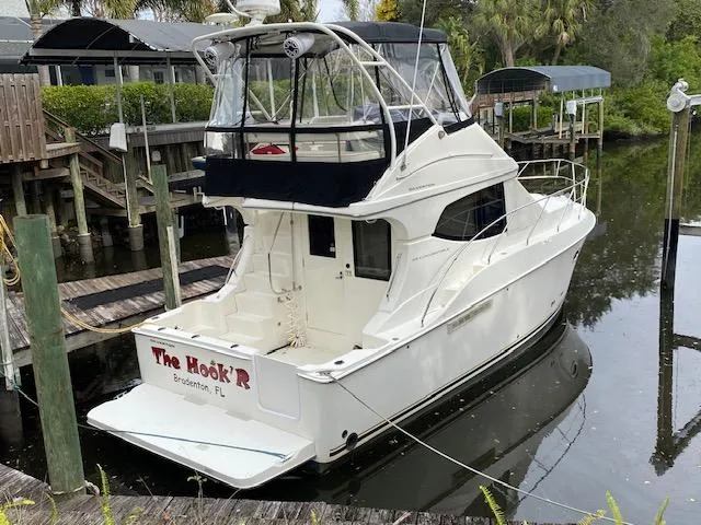 Slide: The Image of 2007 Silverton 33 Convertible boat docked in a marina. - 0