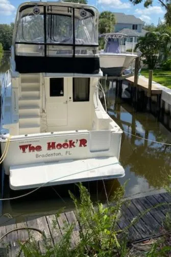 Slide: The Image of 2007 Silverton 33 Convertible docked in a sunny marina. - 1