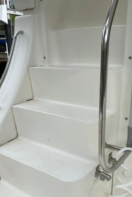 Slide: The Image of 2007 Silverton 33 Convertible interior with red cushioned seating and wooden table. - 13