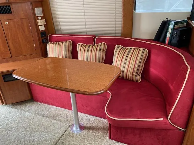 Slide: The Image of Cozy bedroom in 2007 Silverton 33 Convertible boat with plush pillows and floral bedding. - 16