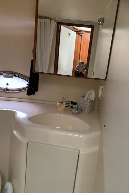 Slide: The Image of Engine compartment of a 2007 Silverton 33 Convertible boat showing pipes and wiring. - 35