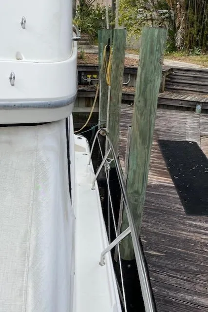 Slide: The Image of Side view of a 2007 Silverton 33 Convertible docked at a wooden pier. - 6
