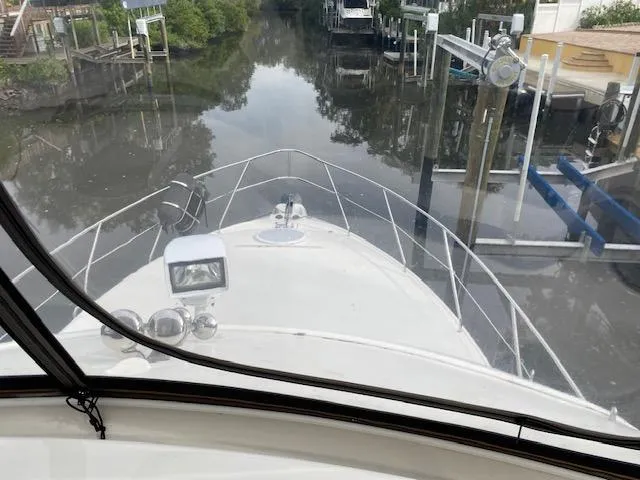 Slide: The Image of View from the helm of a 2007 Silverton 33 Convertible boat in a narrow waterway. - 8