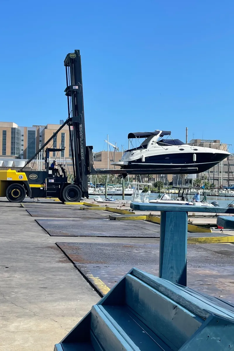 Slide: The Image of Forklift lifting 2006 Sea Ray 280 Sundancer boat at marina. - 13