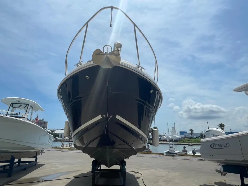 Slide: The Image of 2006 Sea Ray 280 Sundancer boat on a trailer at a marina. - 18