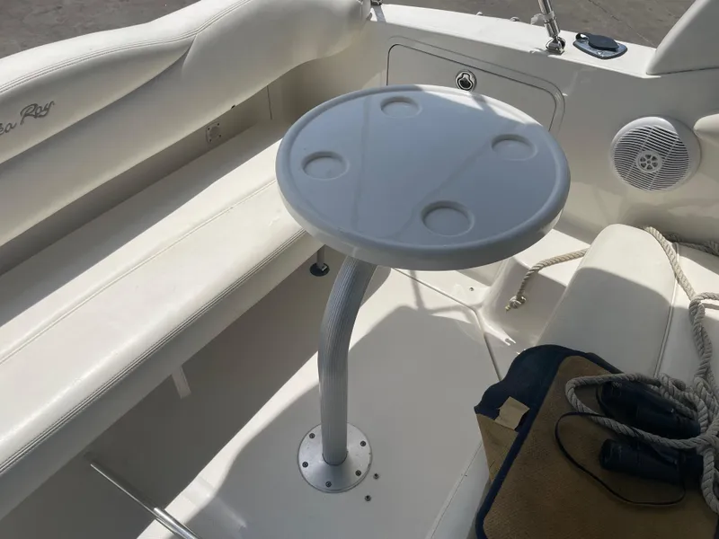 Slide: The Image of 2006 Sea Ray 280 Sundancer boat interior with round table and seating area. - 23