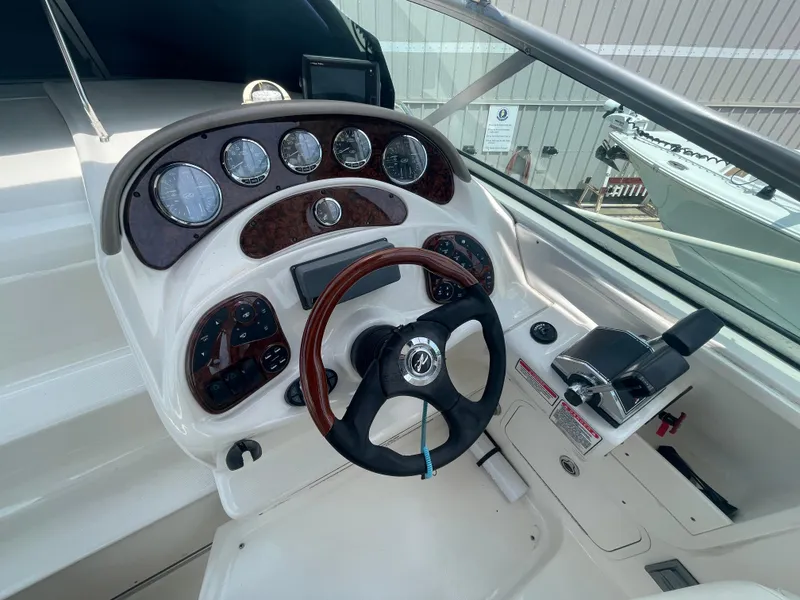 Slide: The Image of 2006 Sea Ray 280 Sundancer helm with gauges and steering wheel. - 24
