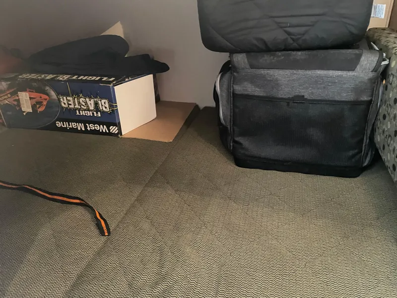 Slide: The Image of Interior storage area of 2006 Sea Ray 280 Sundancer with boxes and bags. - 26