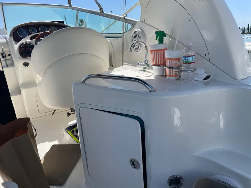 Slide: The Image of Interior of a 2006 Sea Ray 280 Sundancer boat with helm and sink area. - 6