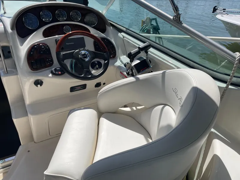 Slide: The Image of 2006 Sea Ray 280 Sundancer helm with white captain's chair and control panel. - 7