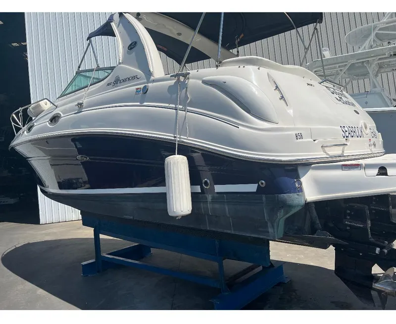 Slide: The Image of 2006 Sea Ray 280 Sundancer boat on a stand in a marina. - 9