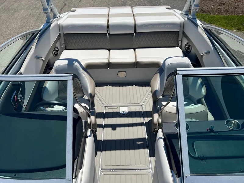 Slide: The Image of 2025 Crownline 220 SS boat interior with white seating and open bow area. - 3