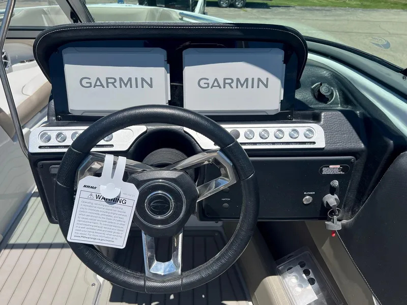 Slide: The Image of 2025 Crownline 220 SS boat dashboard with Garmin navigation screens. - 6