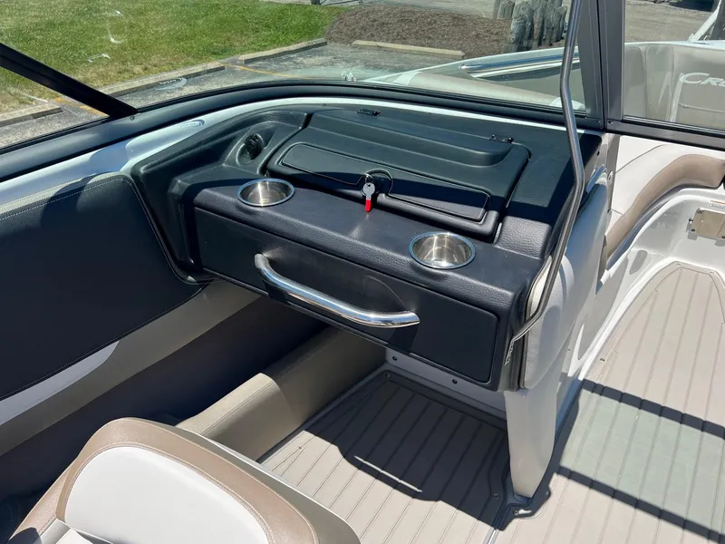 Slide: The Image of 2025 Crownline 220 SS boat interior with dashboard and cup holders. - 9